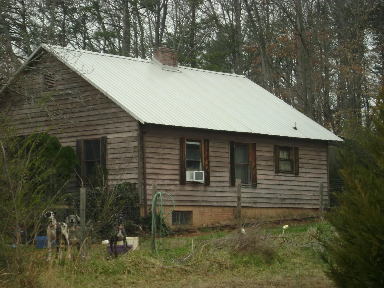 White metal roof on an old wood sided farmhouse, from a Metal Roof Installation job in Parker City